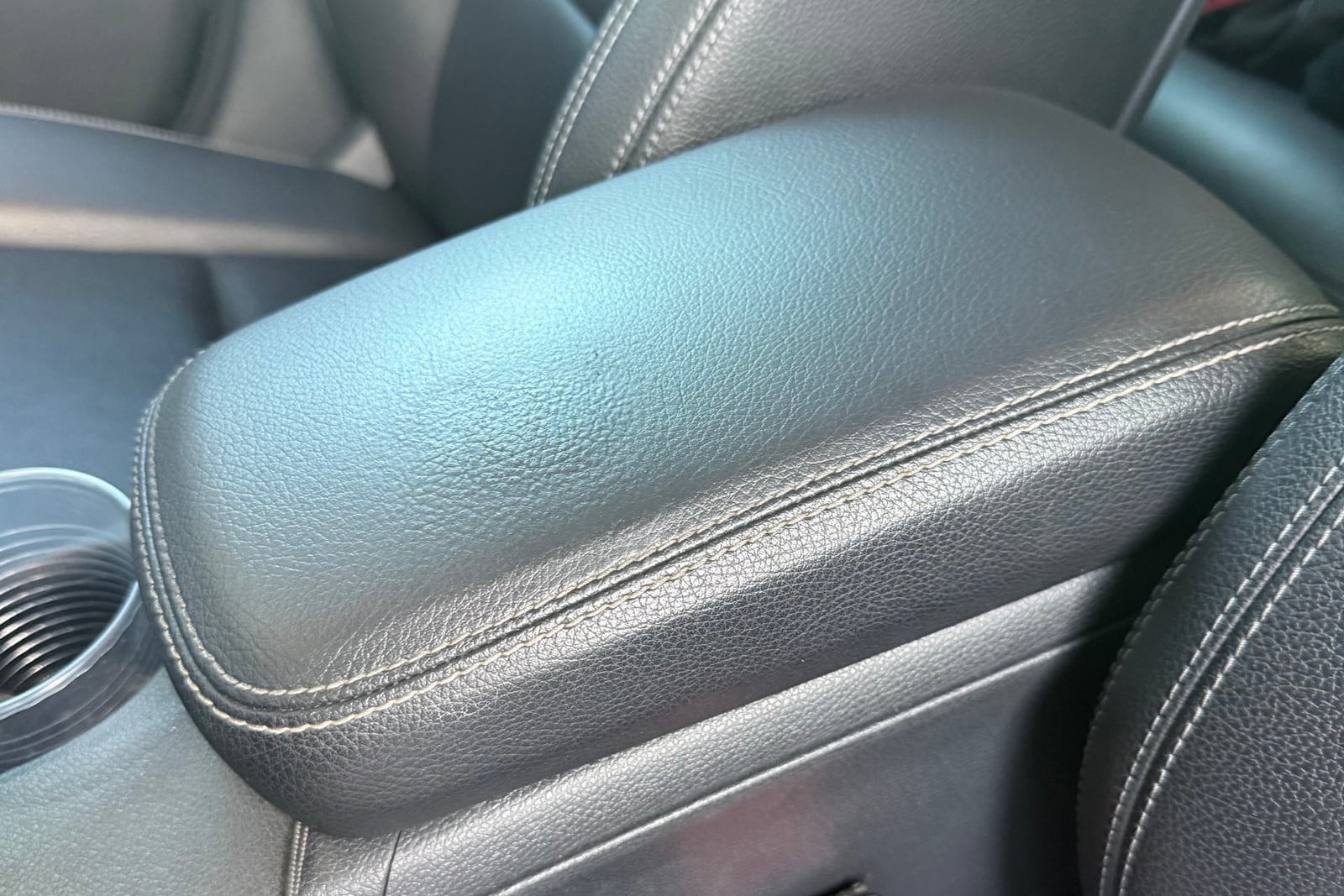 After: Gouged center console armrest — before and after repair by Dr. Vinyl DFW