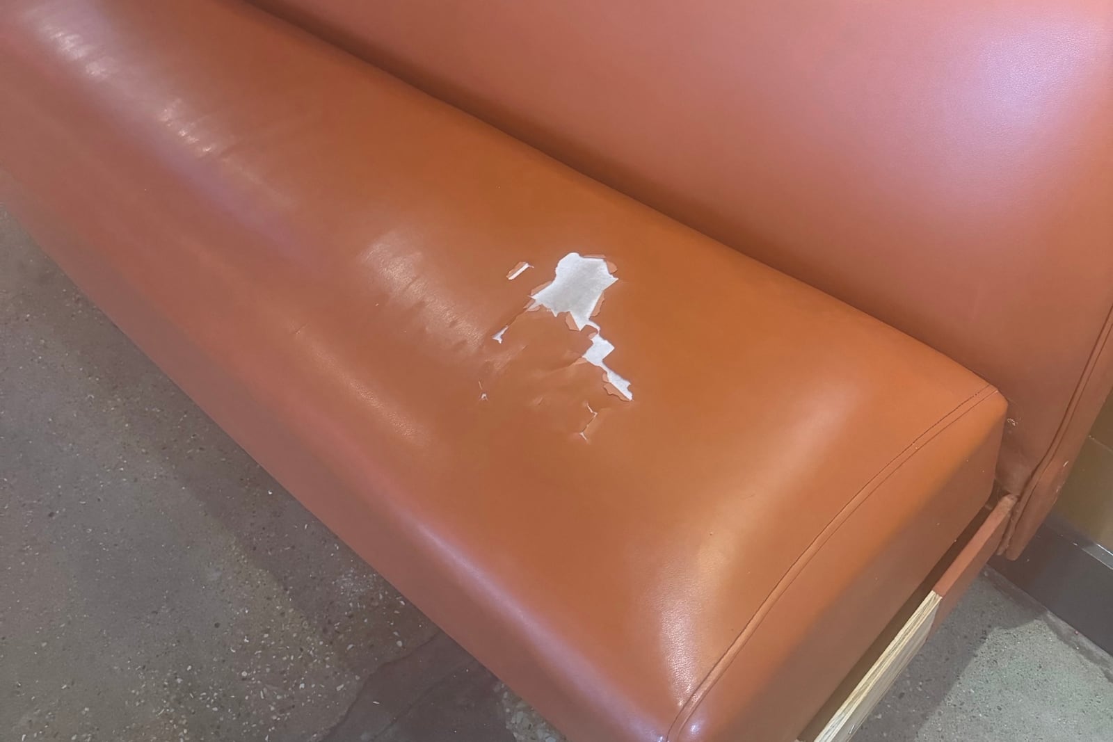 Before: Torn seat cushion on a diner bench — before and after repair by Dr. Vinyl DFW