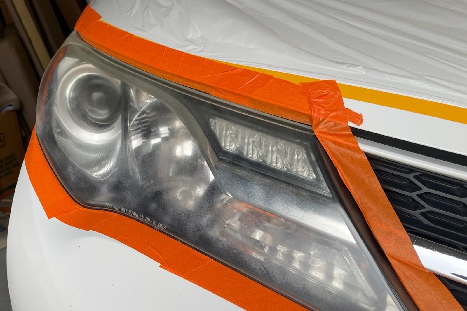 Before: Hazed headlight restored — before and after repair by Dr. Vinyl DFW