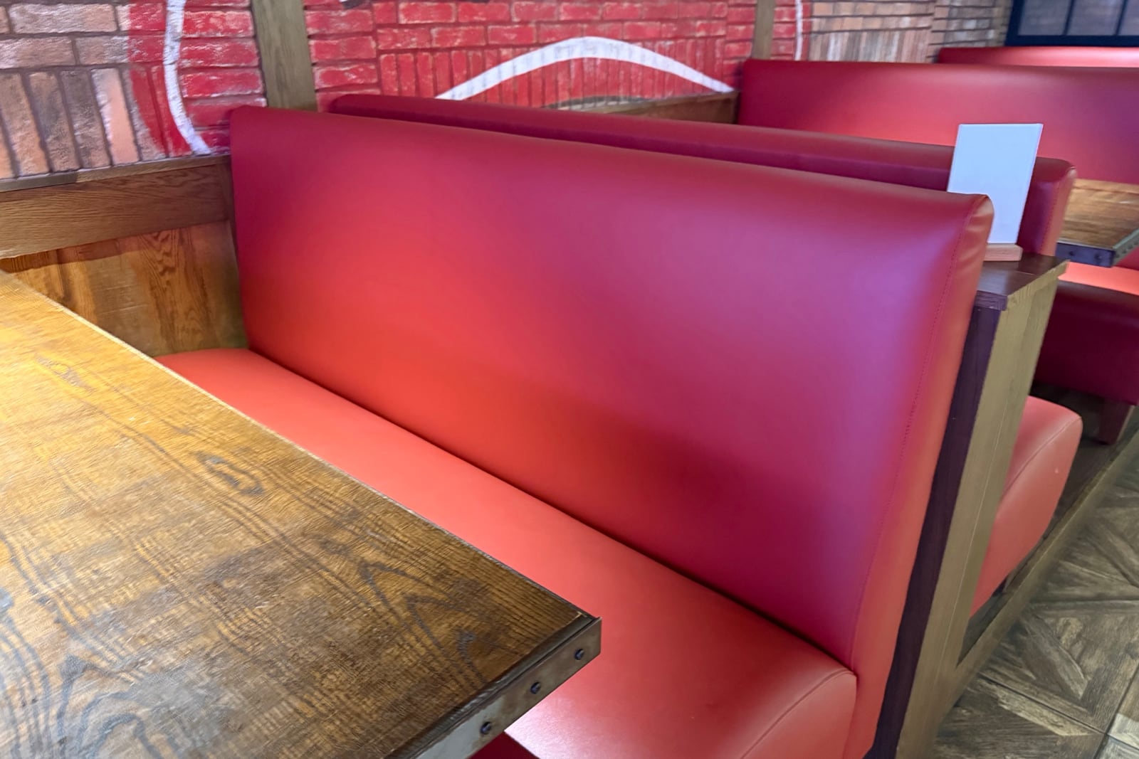 After: Worn tufted booth backs — before and after repair by Dr. Vinyl DFW