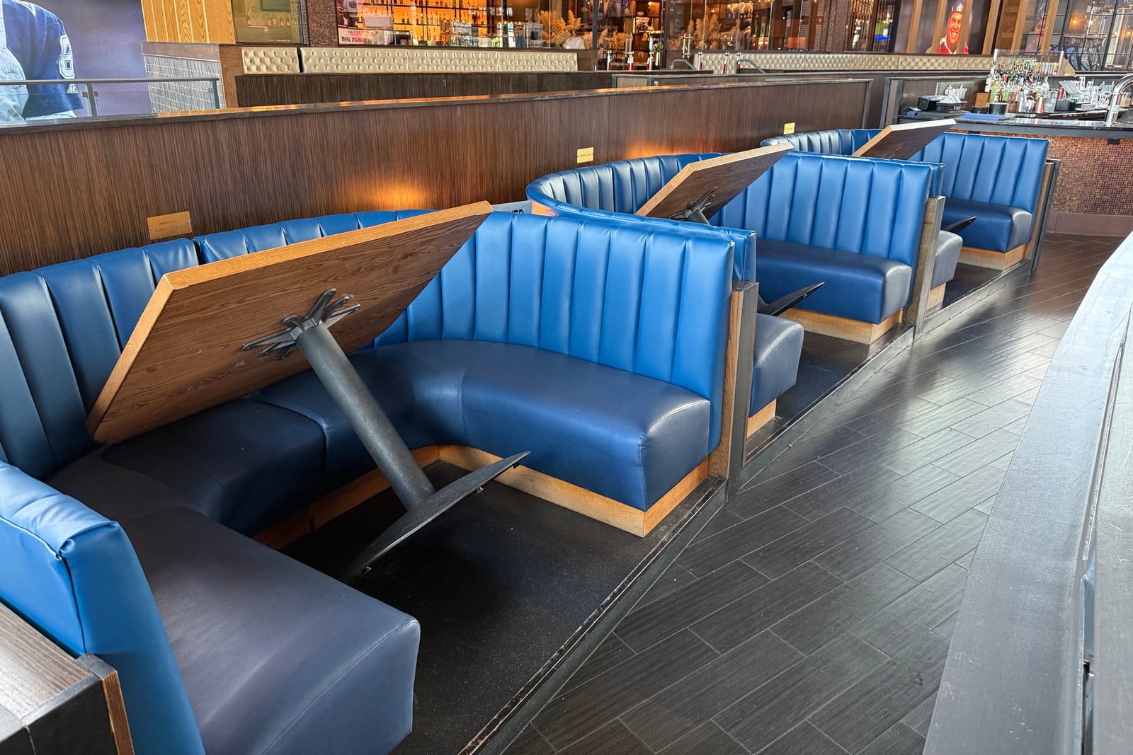After: Faded booth backs in a sports bar — before and after repair by Dr. Vinyl DFW