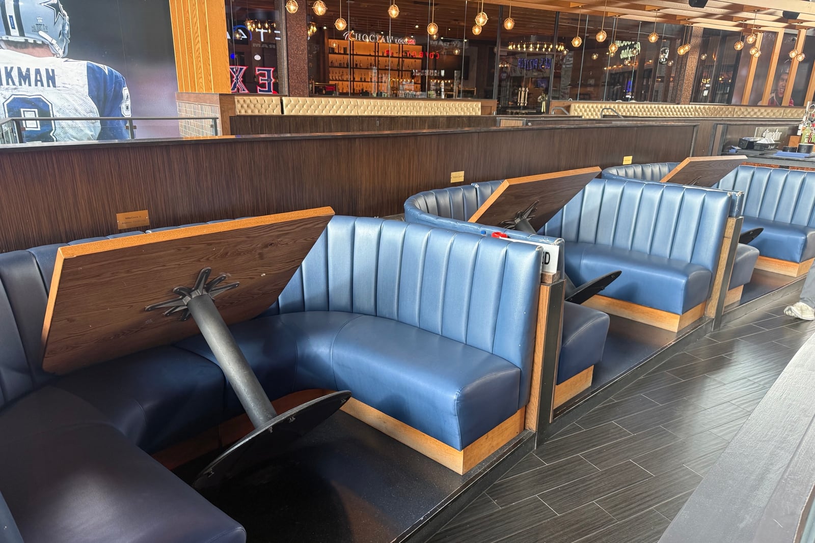 Before: Faded booth backs in a sports bar — before and after repair by Dr. Vinyl DFW
