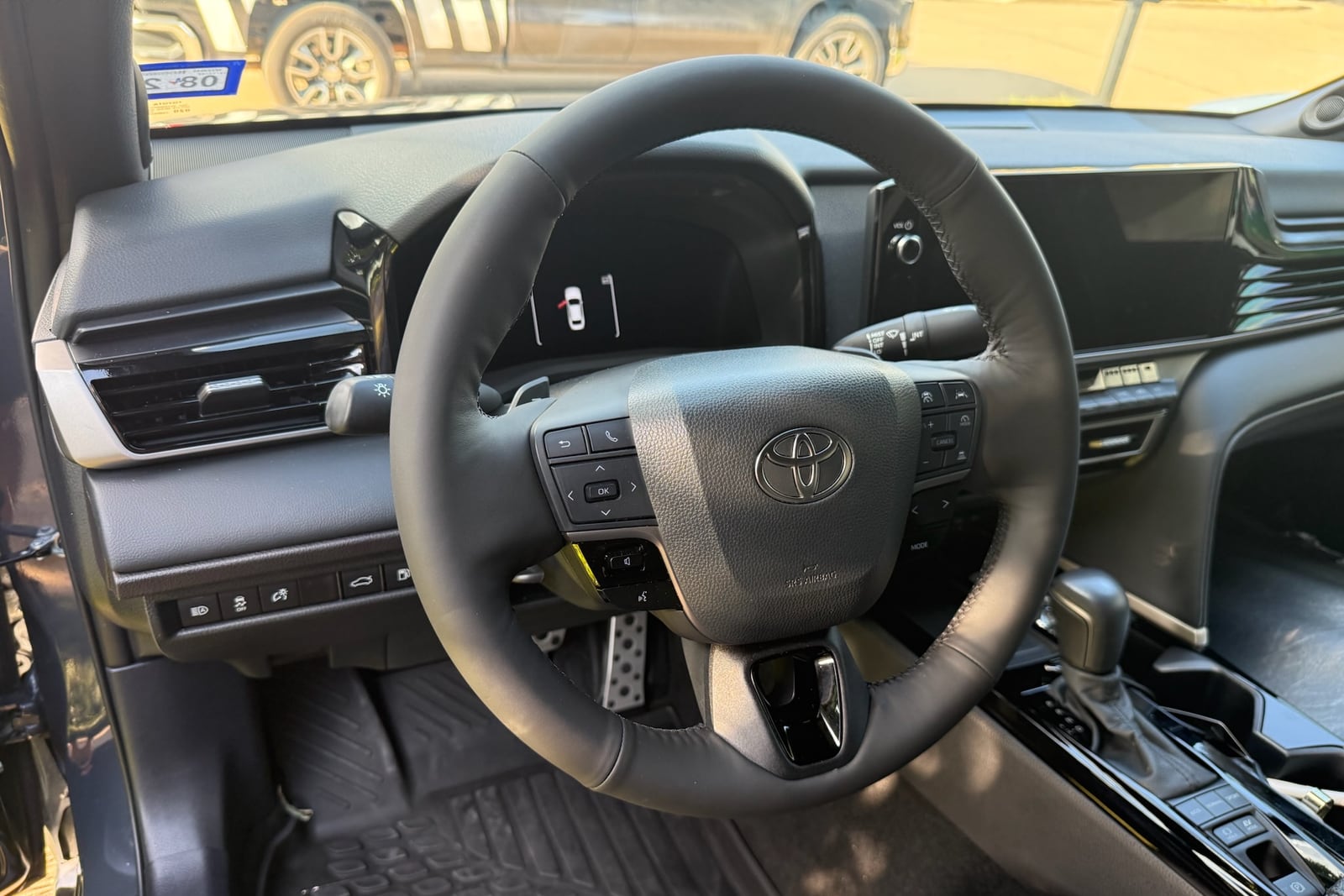 After: Hand-stitched steering wheel cover — before and after repair by Dr. Vinyl DFW