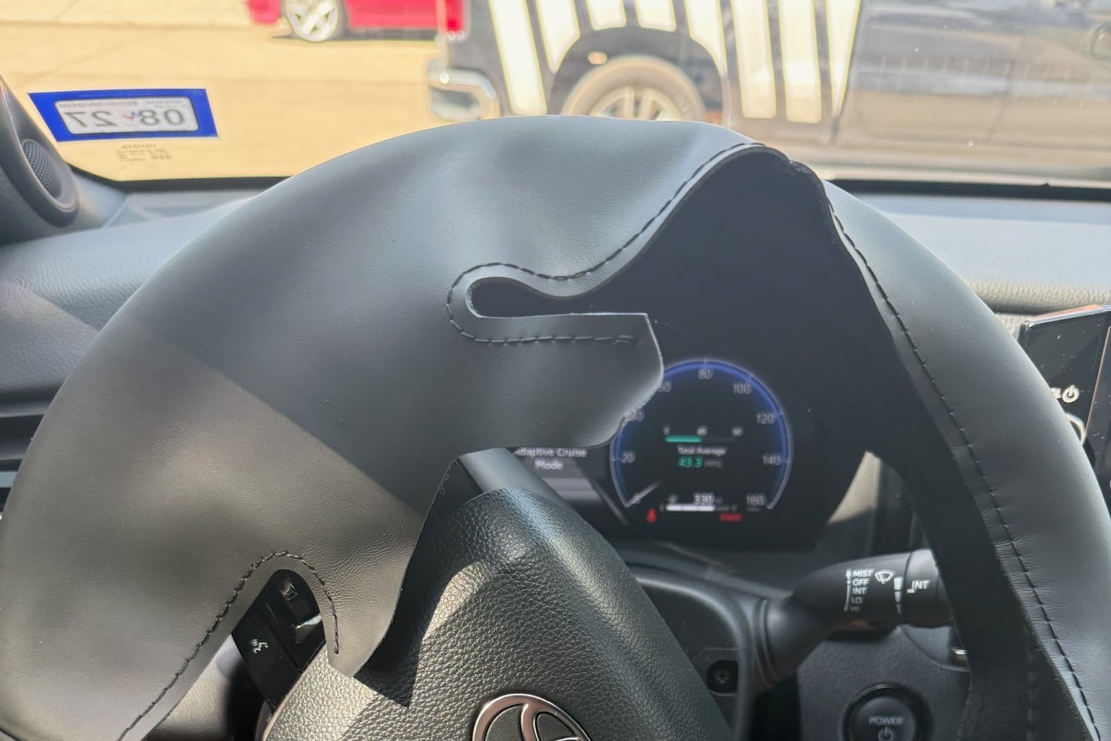 Before: Hand-stitched steering wheel cover — before and after repair by Dr. Vinyl DFW