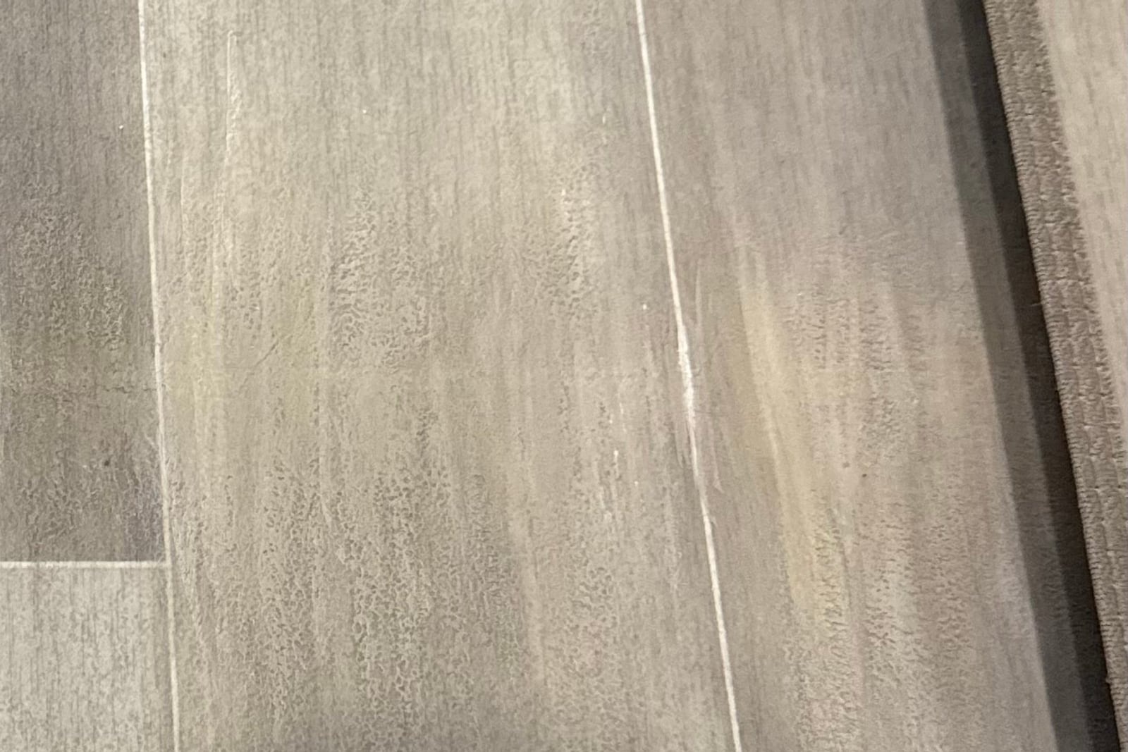 After: Split seam in vinyl flooring — before and after repair by Dr. Vinyl DFW